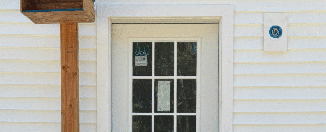Wooden birdhouse mounted above mudroom door during custom home construction in Connecticut, part of Caulkins Homes’ conservation efforts