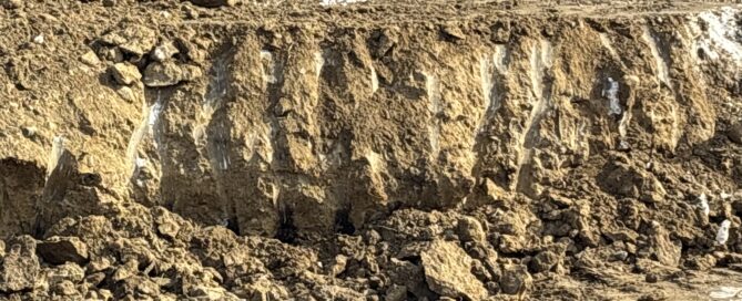 Frozen excavation wall at Mystic CT custom home construction site during winter 2026 deep freeze